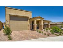 Charming single-Gathering home featuring a two-car garage, beautiful brick driveway and desert landscaping at 6098 Avery Pointe St, Las Vegas, NV 89166