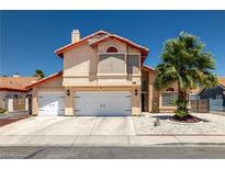 Charming two-story home featuring a stucco exterior, tile roof, and well-manicured landscaping at 6746 Shelter Ln, Las Vegas, NV 89103
