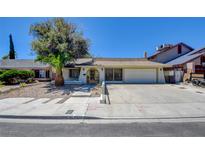 Charming single-story home with desert landscaping, long driveway, and an attached two-car garage at 6822 Garden Grove Ave, Las Vegas, NV 89103