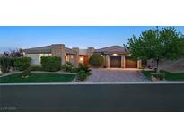 Charming single story home featuring beautiful stone accents and a well manicured lawn at 69 Tapadero Ln, Las Vegas, NV 89135