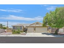 Charming single-story home featuring a two-car garage, well-manicured landscaping, and tile roof at 6920 Haven Hollow Ave, Las Vegas, NV 89130