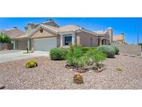 Charming home featuring desert landscaping, a two-car garage, and a welcoming front entrance at 7019 Shadow Crest Dr, Las Vegas, NV 89119