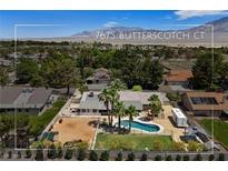 Northwest Las Vegas property featuring an outdoor pool, a horse pen, and mature trees at 7675 Butterscotch Ct, Las Vegas, NV 89131