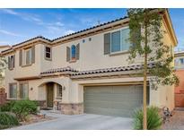 Two-story home with a tile roof, a two-car garage, and mature landscaping in front at 9715 Aleutian St, Las Vegas, NV 89178