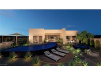 Stunning backyard featuring a pool, lounge chairs, and lush landscaping, perfect for outdoor relaxation and entertaining at 165 Still Shores St, Henderson, NV 89011
