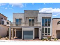 Modern two-story home features a balcony, two-car garage and contemporary architectural design at 1801 Flycatch St, Las Vegas, NV 89138