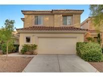 Two-story home with a tile roof, two-car garage, and manicured landscaping at 189 Paxon Hollow Ct, Las Vegas, NV 89148