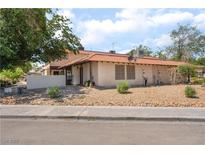 Charming two-story home featuring a red tile roof and low-maintenance desert landscaping, perfect for easy living at 5101 Renault Ave, Las Vegas, NV 89142