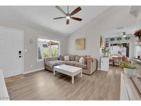 Bright living room featuring a neutral sofa, ceiling fan, and hardwood floors at 5228 Harmony Ave, Las Vegas, NV 89107