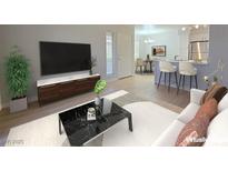 Bright living room featuring modern decor, wood-look flooring, and a sleek marble coffee table at 5710 E Tropicana Ave # 1018, Las Vegas, NV 89122