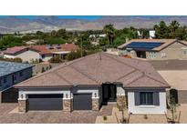 Charming single-story home featuring a beautiful roof, three-car garage, and mountain views in the background at 5851 Slate Rock Ct, Las Vegas, NV 89149