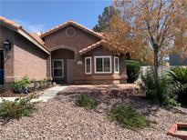 Inviting single-story home with mature trees, low-maintenance landscaping, and charming front facade at 6704 Lost River Ct, Las Vegas, NV 89108