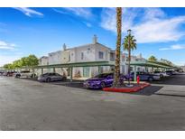 Condominium building with covered parking and well-maintained landscaping on a bright, sunny day at 7100 Pirates Cove Rd # 2076, Las Vegas, NV 89145