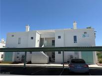 Well-maintained condominium building featuring private covered parking and bright, neutral-toned exterior at 7100 Pirates Cove Rd # 2076, Las Vegas, NV 89145