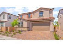 Charming two-story home with a brick driveway, stone accents, desert landscaping, and neutral color palette at 765 Cloud Creek St, Henderson, NV 89011