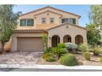 Charming two-story home with a covered front porch and a well-manicured lawn at 7854 Brianna Cheerful Ave, Las Vegas, NV 89178
