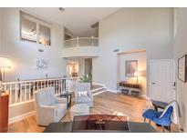 Bright, open-concept living room boasts high ceilings, modern flooring, and stylish decor at 8221 Ebony Peak St, Las Vegas, NV 89143
