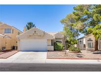 Charming single-story home with a well-manicured lawn and attached two-car garage at 8324 Tide Pool Dr, Las Vegas, NV 89128