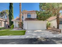 Charming two-story home with a red tile roof, manicured lawn, and a spacious two-car garage at 8809 Beach Front Dr, Las Vegas, NV 89117