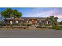 Charming single-story home featuring a tile roof, solar panels, and meticulously landscaped front yard at 9015 S Tenaya Way, Las Vegas, NV 89113