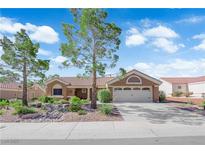 Charming single-story home featuring a tile roof, desert landscaping and a two-car garage at 9237 Quail Ridge Dr, Las Vegas, NV 89134