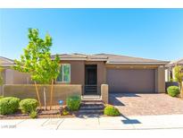 Charming single-story home featuring a low wall, front garden, and a two-car garage at 10711 Silver Pond Ave, Las Vegas, NV 89135