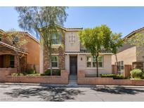 Inviting two-story home with a stone facade and a well-maintained front yard, showcasing curb appeal at 11063 Mount George St, Las Vegas, NV 89179