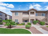 Inviting exterior with landscaped grounds, beige stucco, private balconies, and covered entryways, providing great curb appeal at 2305 W Horizon Ridge Pkwy # 611, Henderson, NV 89052
