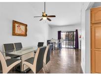 Bright dining room boasts a modern glass table, stylish chairs, and sleek hardwood flooring at 2851 S Valley View Blvd # 1120, Las Vegas, NV 89102