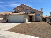 Charming two-story home with a well-maintained front yard and neutral color scheme at 3238 Canyon Terrace Dr, Laughlin, NV 89029