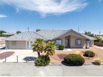 Charming single-story home featuring a tiled roof, landscaped front yard, and inviting curb appeal at 3241 E Winery Rd, Pahrump, NV 89048