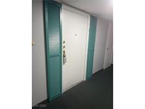 Apartment front door flanked with teal colored shutters at 3930 University Center Dr # 901, Las Vegas, NV 89119