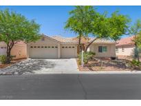 Charming single-story home with a tile roof, mature trees, and a spacious three-car garage at 4029 Ricebird Way, North Las Vegas, NV 89084