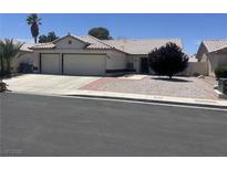 Charming single-story home featuring a three car garage and desert landscaping for low maintenance appeal at 4323 Pageantry Falls Dr, North Las Vegas, NV 89031