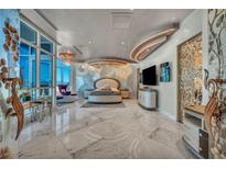 Spacious primary bedroom with a sitting area, floor-to-ceiling windows, and an elegant round platform bed at 4525 Dean Martin Dr # 2503, Las Vegas, NV 89103