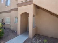 Inviting front entrance of a home with an arched doorway and desert landscaping at 5751 E Hacienda Ave # 137, Las Vegas, NV 89122