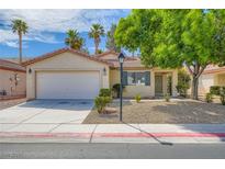 Charming single-story home featuring a two-car garage, desert landscaping, and mature shade trees at 7547 Rolling River Dr, Las Vegas, NV 89131
