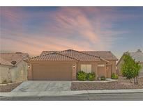 Charming single-story home with a well-maintained yard and a two-car garage at 7825 White Grass Ave, Las Vegas, NV 89131