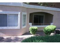 Charming condo featuring stucco siding, neutral color scheme, and a private patio with a sliding glass door and covered entry at 830 Carnegie St # 1011, Henderson, NV 89052