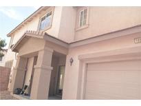 Two-story home featuring a covered porch, attached garage, and stucco exterior at 1025 Appaloosa Hills Ave, North Las Vegas, NV 89081