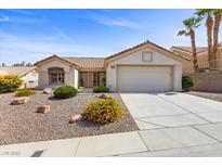 Charming home featuring a tile roof, a two car garage, and desert landscaping at 10413 Marymont Pl, Las Vegas, NV 89134