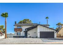 Charming two-story home featuring updated finishes and a black garage door at 2611 Siesta Ave, Las Vegas, NV 89121