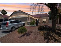 Charming single-story home featuring a tile roof, desert landscaping, and a two-car garage at 2716 Orchid Moon Ct, North Las Vegas, NV 89031