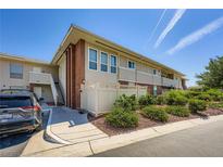 Two-story condo with brick accents, multiple windows, and a well-maintained landscaped yard at 2838 Geary Pl # 4017, Las Vegas, NV 89109