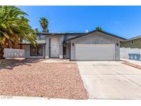 Charming single-Gathering home featuring a well-maintained front yard and an attached two-car garage at 3158 Brockington Dr, Las Vegas, NV 89120