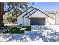 Charming single-Gathering home with a manicured front yard and a two-car garage on a sunny day at 363 El Pico Dr, Henderson, NV 89014