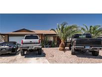 Cozy single-story home featuring mature landscaping and a gravel yard for low maintenance at 517 Longtree Ave, Henderson, NV 89011