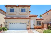 Charming two-story home with a white garage door and a red tile roof in a suburban neighborhood at 5282 Monterey Park Cir, Las Vegas, NV 89146