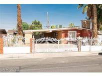 Charming single story home with a unique decorative metal fence and desert landscaping at 624 N Bruce St, Las Vegas, NV 89101