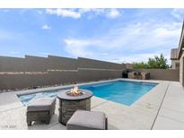 Beautiful backyard with a pool, hot tub, fire pit, and outdoor seating area, perfect for entertaining and relaxation at 6421 Winecup St, Las Vegas, NV 89149